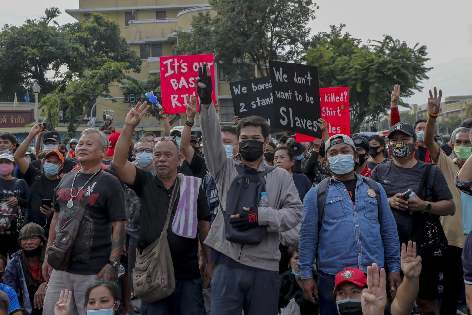 Pro-democracy protesters display placards and flash three-finger salutes as they gather for a street march and a rally at Democracy Monument in Bangkok, Thailand, Sunday, Nov. 8, 2020. The protesters continue to gather Sunday, led by their three main demands of Prime Minister Prayuth Chan-ocha's resignation, changes to a constitution that was drafted under military rule and reforms to the constitutional monarchy. (AP Photo/Sakchai Lalit)