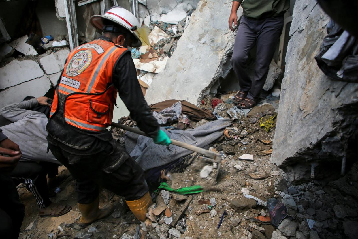 A Palestinian rescuer searches for casualties at the site of an Israeli strike on a house, amid the ongoing conflict between Israel and the Palestinian Islamist group Hamas, in Rafah, in the southern Gaza Strip on 7 May 2024 (Reuters)