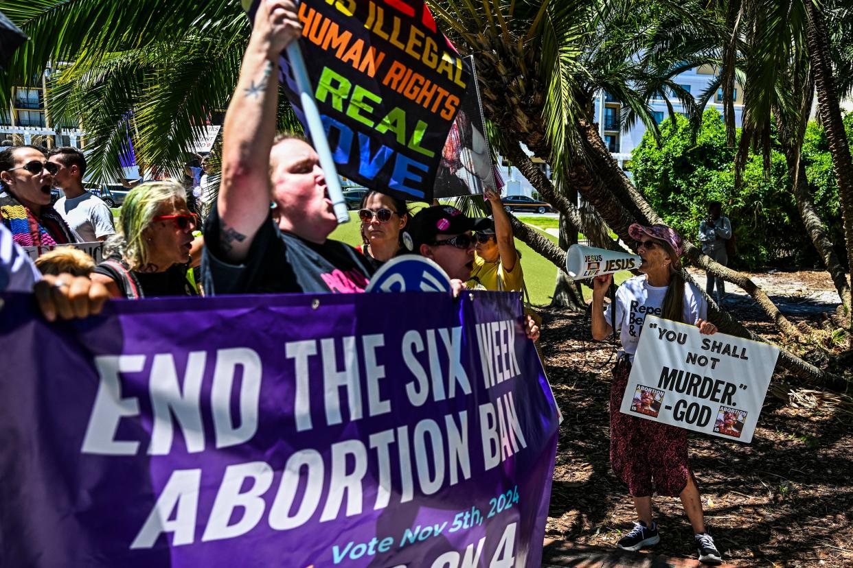 Anti-abortion activists (R) protest near the "Rally for Our Freedom" to protect abortion rights for Floridians, in Orlando, Florida, on April 13, 2024. Florida Rising, Floridians Protecting Freedom, and coalition partners officially launched the "Yes on 4" campaign. Florida's Supreme Court on April 1, 2024, paved the way for a ban on abortion after just six weeks of pregnancy, even as it allowed Amendment 4, protecting abortion rights, to be on the ballot in the November 2024 election. (Photo by CHANDAN KHANNA / via Getty Images)