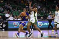 Morehead State guard Morgan Browning (4) drives to the basket as Baylor guard Jordan Lewis (3) defends during the first half of an NCAA college basketball game in Waco, Texas, Tuesday, Nov. 30, 2021. (AP Photo/Tony Gutierrez)