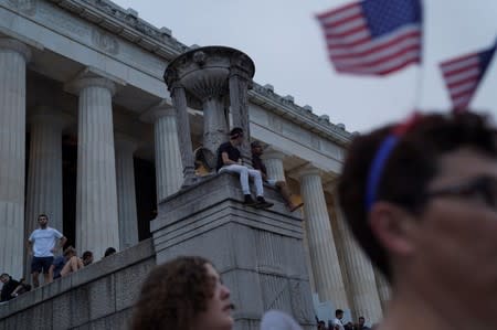 FILE PHOTO - People sit along the Lincoln Memorial prior to a firework show during the 4th of July Independence Day celebrations at the National Mall in Washington