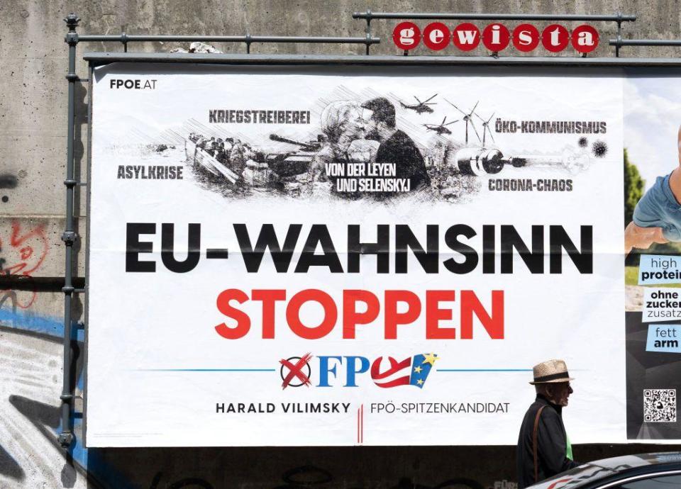 A pedestrian walks past a billboard with an election poster for Harald Vilimsky, top candidate of national-conservative and right-wing Freedom Party of Austria FPO