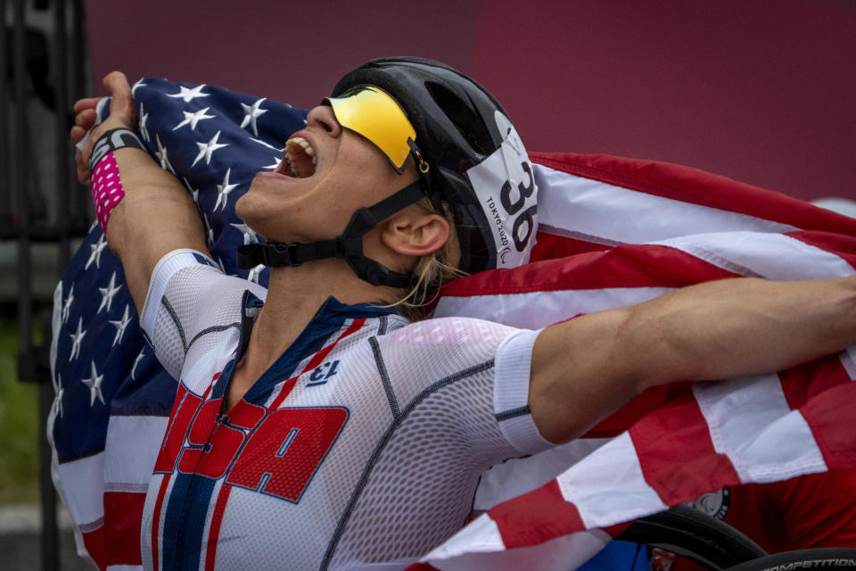 Oksana Masters, from USA, celebrates after wining at Women's H5 Road Race at the Fuji International Speedway at the Tokyo 2020 Paralympic Games, Wednesday, Sept. 1, 2021, in Tokyo, Japan. (AP Photo/Emilio Morenatti)