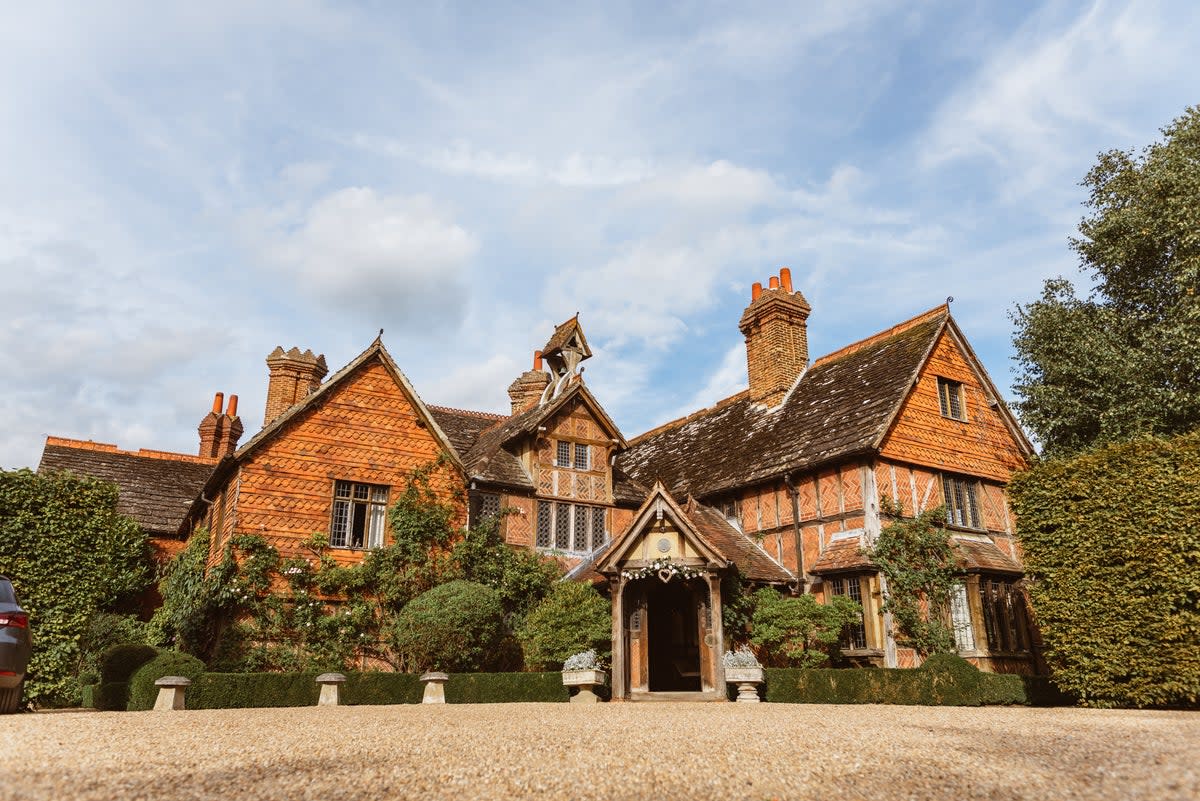 Cosy up by the fireplace in this Tudor-style hotel (Langshott Manor)