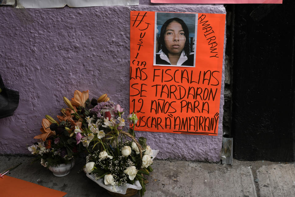 A basket of flowers sits next to a poster of Amarirany Roblero who went missing 12 years ago, during a protest outside an apartment rented by a suspected serial killer where evidence related to Roblero was found, in the Iztacalco neighborhood of Mexico City, Friday, April 26, 2024. (AP Photo/Marco Ugarte)