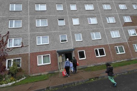 People enter a building, that also serves as an accommodation facility for refugees and was searched by German police on Tuesday, in the village of Suhl, Germany, October 25, 2016. REUTERS/Kai Pfaffenbach