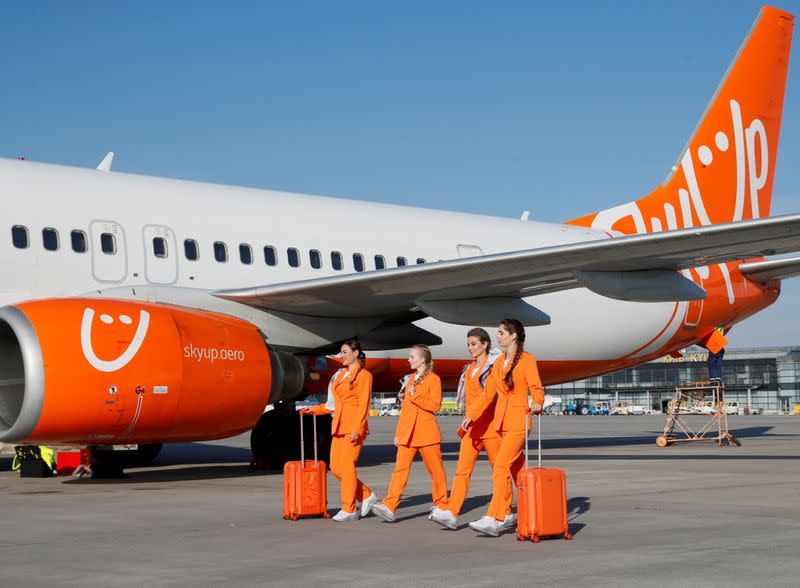 SkyUp Airlines flight attendants present a new uniform at an airport outside Kyiv