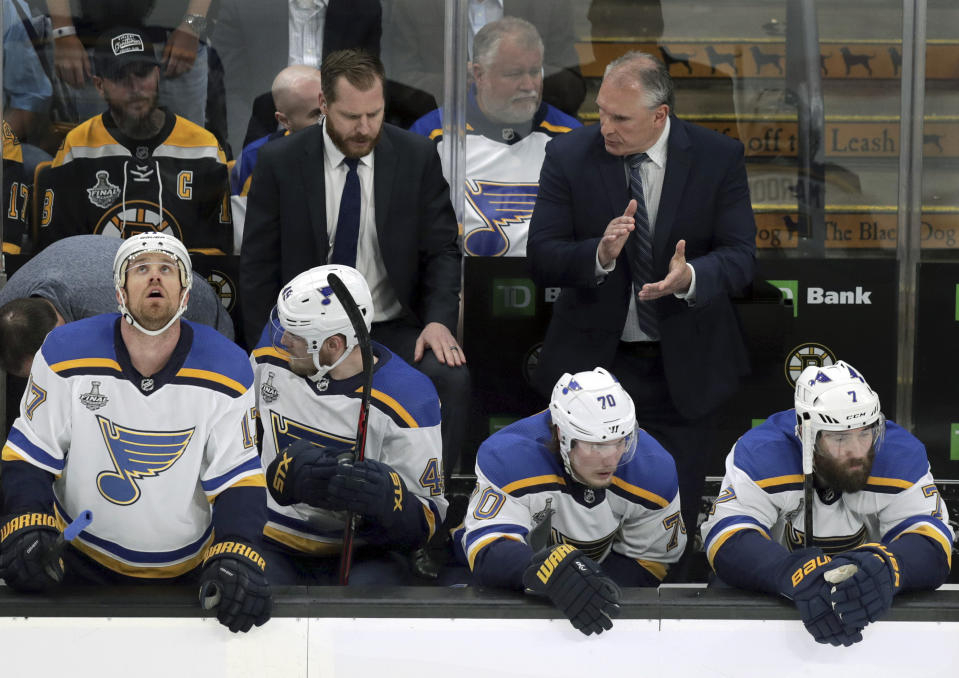 St. Louis Blues head coach Craig Berube, right rear, exhorts his players during the first period in Game 5 of the NHL hockey Stanley Cup Final against the Boston Bruins, Thursday, June 6, 2019, in Boston. (AP Photo/Charles Krupa)