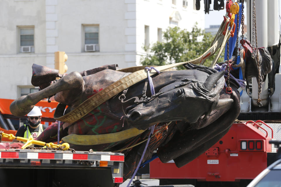 Crews lower the statue Confederate General J.E.B. Stuart in preparation for transport after removing it from it's pedestal on Monument Avenue Tuesday July 7, 2020, in Richmond, Va. The statue is one of several that will be removed by the city as part of the Black Lives Matter reaction. (AP Photo/Steve Helber)