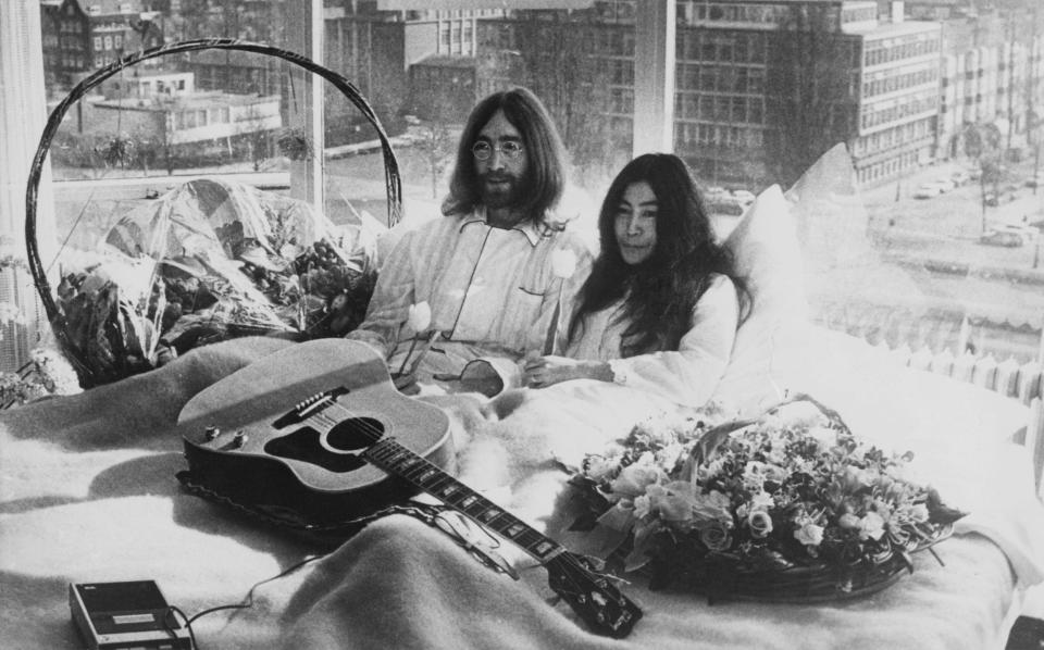 Beatle John Lennon and his wife of a week Yoko Ono in their bed in the Presidential Suite of the Hilton Hotel, Amsterdam in 1969 - Getty 