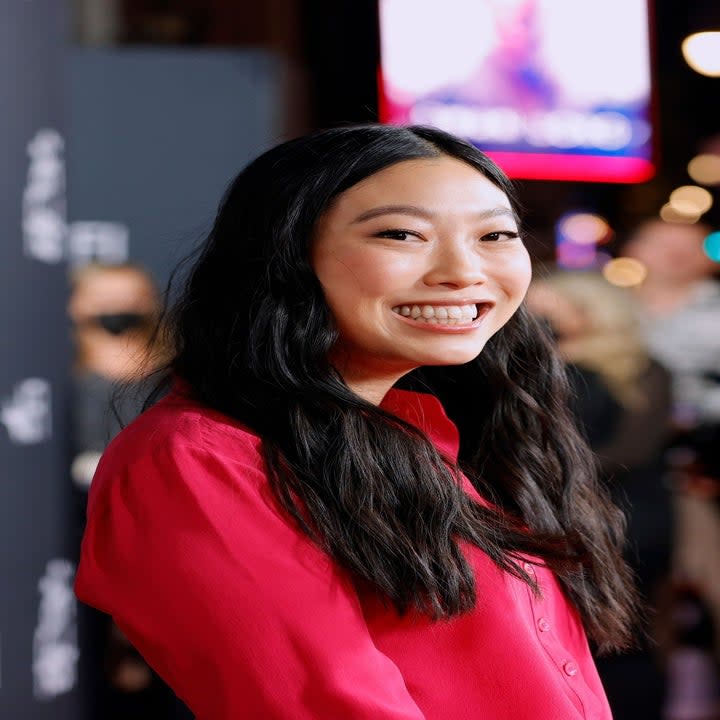 Awkwafina smiling at the camera