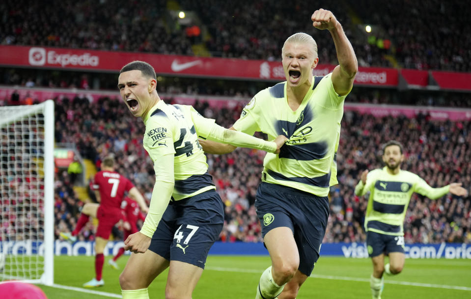 Manchester City's Phil Foden, left, celebrates with Manchester City's Erling Haaland after scores a disallowed goal during the English Premier League soccer match between Liverpool and Manchester City at Anfield stadium in Liverpool, Sunday, Oct. 16, 2022. (AP Photo/Jon Super)