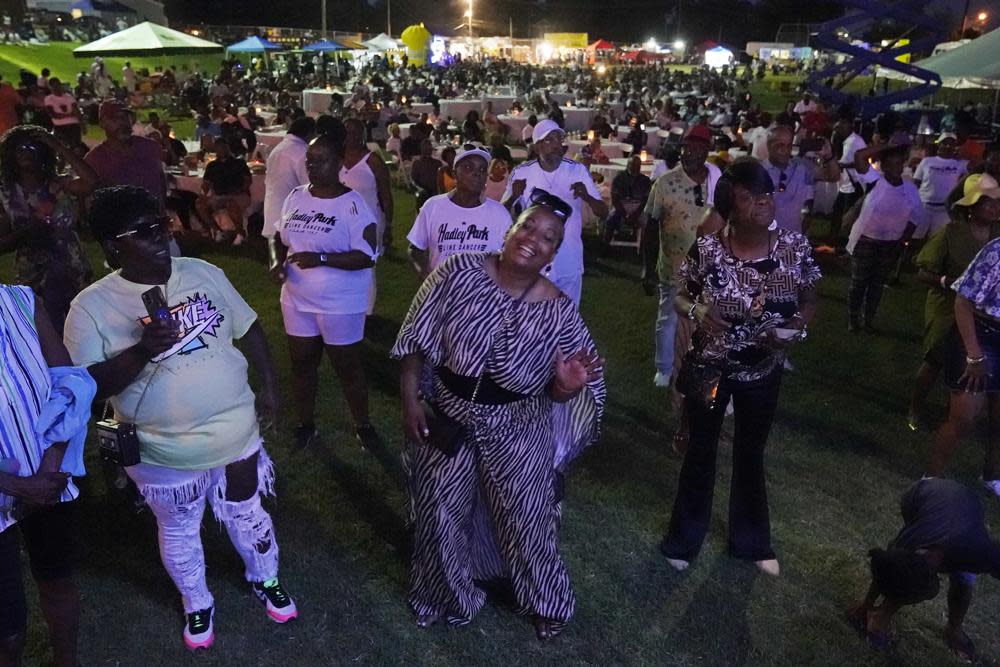 People dance as they listen to music at the Jefferson Street Jazz & Blues Festival July 23, 2022, in Nashville, Tenn. Hundreds of tourism-related projects nationwide, including the festival, collectively are getting about $2.4 billion from the American Rescue Plan, according to an Associated Press analysis of funds flowing from last year’s wide-ranging coronavirus relief law. (AP Photo/Mark Humphrey)