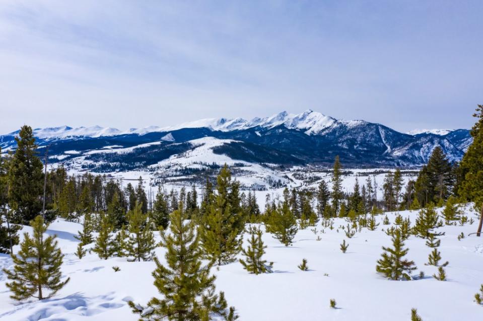 Rocky Mountain Peaks Above Frisco Colorado Winter Pine Tree Landscape via Getty Images