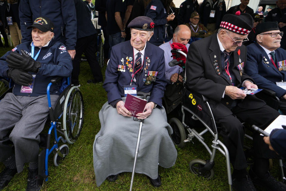 British World War II veteran John King, center, attends a service at the Pegasus Bridge memorial in Benouville, Normandy, France, Wednesday, June 5, 2024. World War II veterans from across the United States as well as Britain and Canada are in Normandy this week to mark 80 years since the D-Day landings that helped lead to Hitler's defeat. (AP Photo/Virginia Mayo)