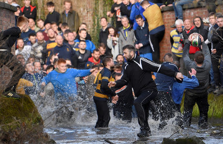 Players fight for the ball during the annual Shrovetide football match in Ashbourne, Britain March 5, 2019. REUTERS/Toby Melville