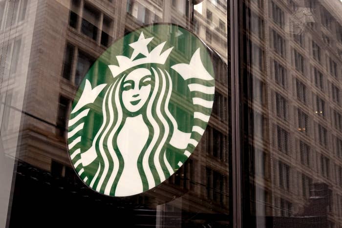 A Starbucks logo hangs in the window of one of the chain's coffee shops in the Loop on January 04, 2022 in Chicago, Illinois