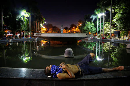 People sleep in the open around a fountain in Manila, Philippines early October 24, 2016. REUTERS/Damir Sagolj