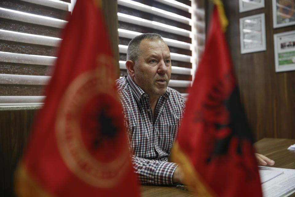 Hysni Gucati head of the War Veterans Organization of the Kosovo Liberation Army speaks during an interview with The Associated Press regarding his co-fighter former Kosovo Liberation Army commander Salih Mustafa after news of his arrest, in capital Pristina, Thursday, Sept. 24, 2020. A special international court said Thursday that a former commander of the separatist fighters in Kosovo's 1998-1999 war has been arrested as part of a war crimes and crimes against humanity probe stemming from the conflict with Serbia. (AP Photo/Visar Kryeziu)