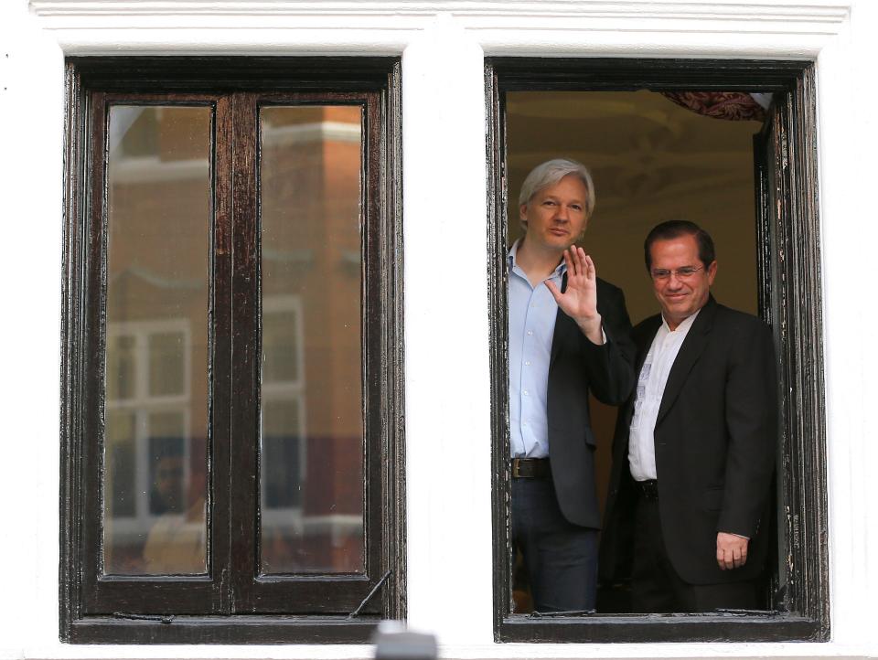 WikiLeaks founder Julian Assange, left, appears with Ecuador's Foreign Minister Ricardo Patino on the balcony of the Ecuadorian Embassy in London, Sunday, June 16, 2013. 