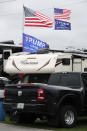 Flags supporting President Donald Trump fly in the infield days before his appearance at the NASCAR Daytona 500 auto race at Daytona International Speedway, Friday, Feb. 14, 2020, in Daytona Beach, Fla. Trump will find Daytona International Speedway as welcoming as one of his campaign rallies. (AP Photo/John Raoux)