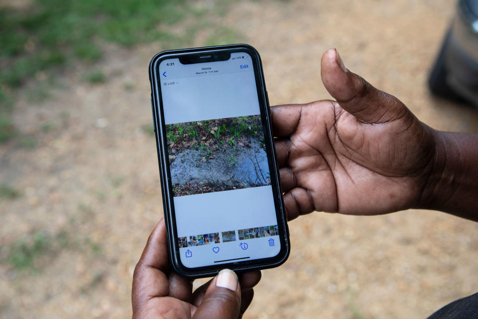 A resident shares photos of the sewage rising in their yard after heavy rainfall.<span class="copyright">Charity Rachelle for TIME</span>