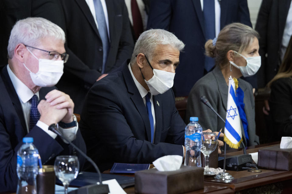 Israeli Foreign Minister Yair Lapid, center, meets with Egyptian Foreign Minister Sameh Shoukry at Tahrir Palace in Cairo, Egypt, Thursday, Dec. 9, 2021. (AP Photo/Nariman El-Mofty)