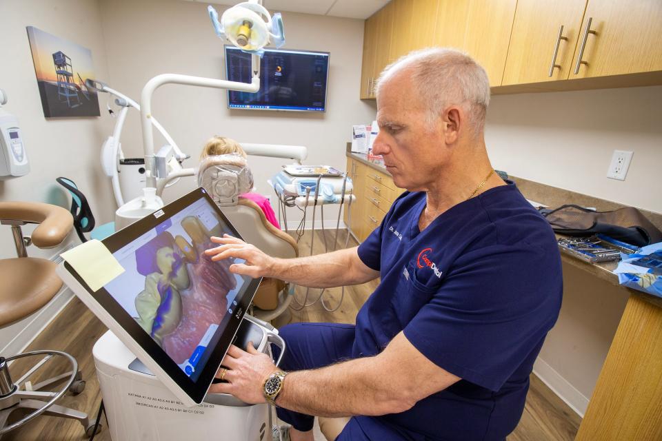 Dr. Jack Campi, co-owner of Campi Dental, a fourth-generation dental practice located in Wall that's celebrating its 90th anniversary in business this year, looks over a scan before creating a same day crown for a patient at Campi Dental in Wall, NJ Monday, February 6, 2023. 