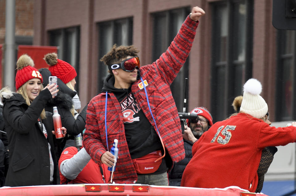 Kansas City Chiefs quarterback Patrick Mahomes cheers with the crowd during a parade through downtown Kansas City, Mo., Wednesday, Feb. 5, 2020, to celebrate the Chiefs victory in the NFL's Super Bowl 54. (AP Photo/Reed Hoffmann)