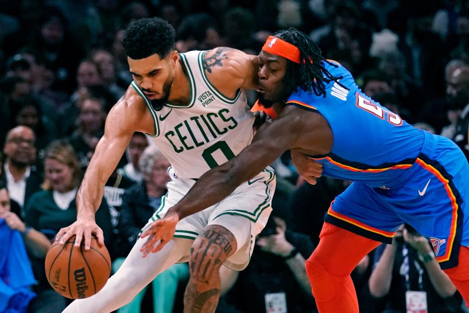 Thunder forward Luguentz Dort tries to steal the ball from Celtics forward Jayson Tatum during the first half Monday in Boston.