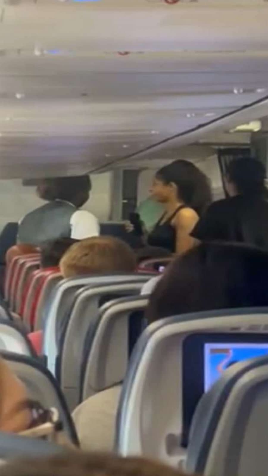 PHOTO: In this screen grab from a video, an airline staff member is shown speaking to a passenger after Delta Airline passengers passed out from the heat after sitting on the tarmac in 115 degree temperatures in Las Vegas, on July 17, 2023. (April Love)