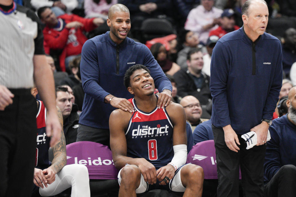 A member of the Washington Wizards staff massages forward Rui Hachimura (8) after he exited in the second half of an NBA basketball game against the Orlando Magic, Saturday, Jan. 21, 2023, in Washington. (AP Photo/Jess Rapfogel)