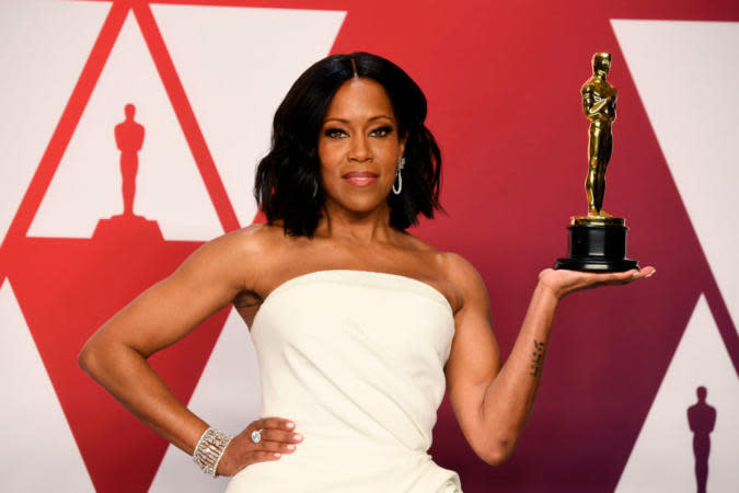 Here are some of the most iconic Regina King movies and TV shows that have defined her career. Pictured: Regina King smiling on the Oscar's red carpet while holding her Academy Award in the palm of her hand. | HOLLYWOOD, CALIFORNIA - FEBRUARY 24: Actor Regina King, winner of the Best Actress in a Supporting Role award for “If Beale Street Could Talk” poses in the press room during at Hollywood and Highland on February 24, 2019 in Hollywood, California. (Photo by Frazer Harrison/Getty Images)