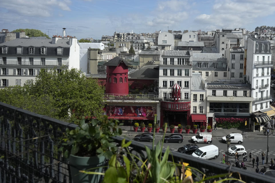 The Moulin Rouge (Red Mill) is seen Thursday, April 25, 2024 in Paris. The windmill from the Moulin Rouge, the 19th century Parisian cabaret, has fallen off the roof overnight along with some of the letters in its name. (AP Photo/Thibault Camus)