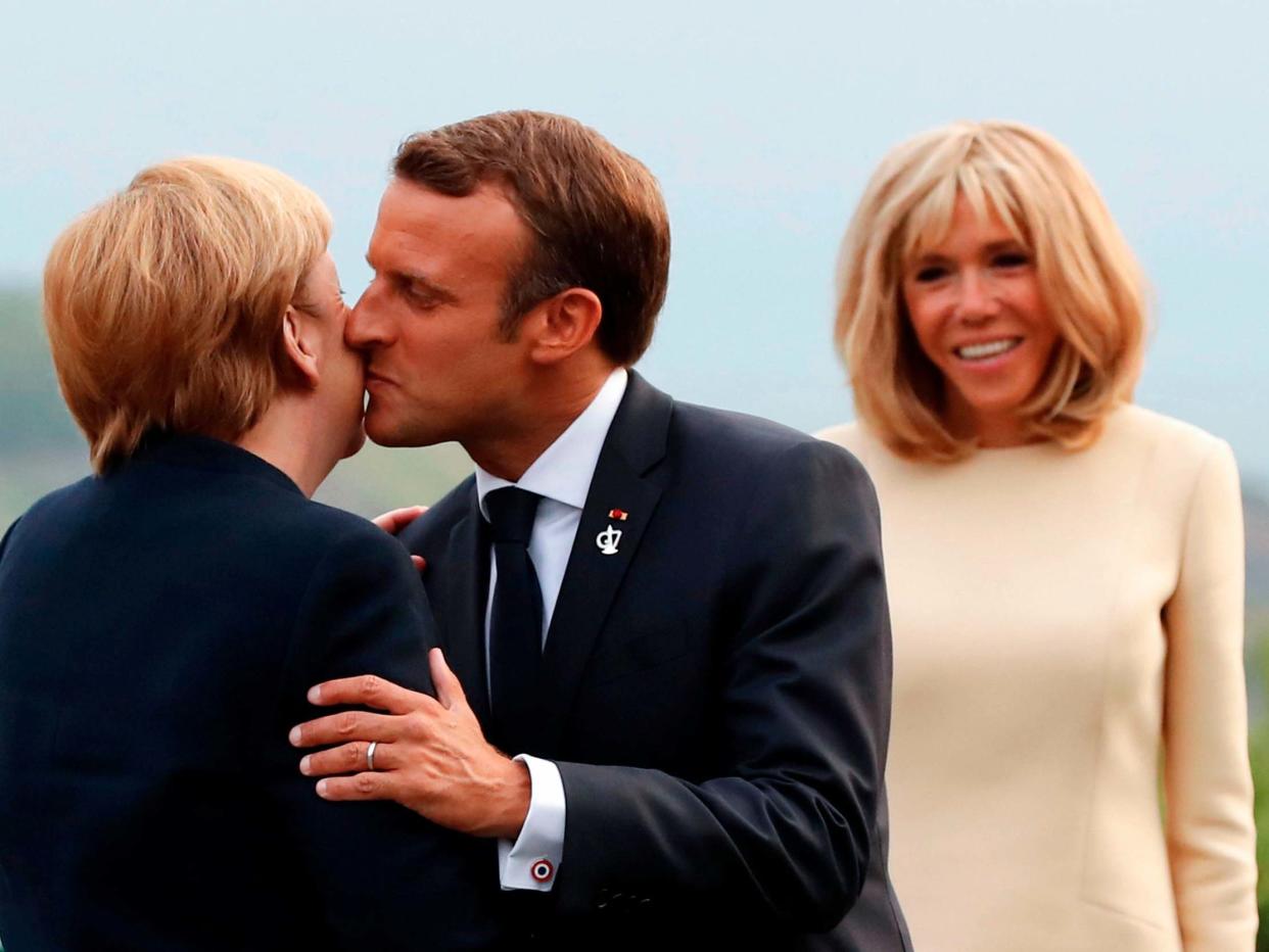 Brigitte Macron looks on as her husband greets German chancellor Angela Merkel at the G7 summit: AFP/Getty Images