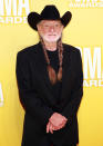  <p class="MsoNormal">Willie Nelson looked like he’d rather be “on the road again” versus posing on the red carpet in an all-black ensemble and his signature braids. </p> 