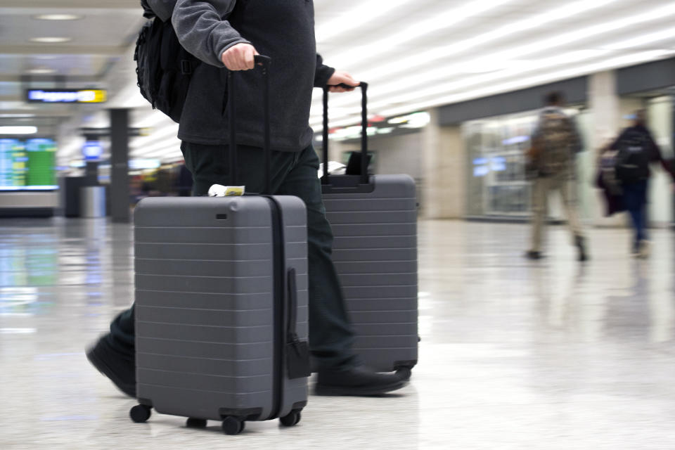 FILE - In this March 26, 2019, file photo, an airline passenger walk in the arrivals terminal at Dulles International Airport in Dulles, Va. Newly documents filed in a federal lawsuit claim that U.S. government searches of phones and laptops at airports are on the rise and are being conducted for reasons beyond immigration and customs enforcement. There were 33,295 searches in fiscal 2018.  (AP Photo/Cliff Owen, File)