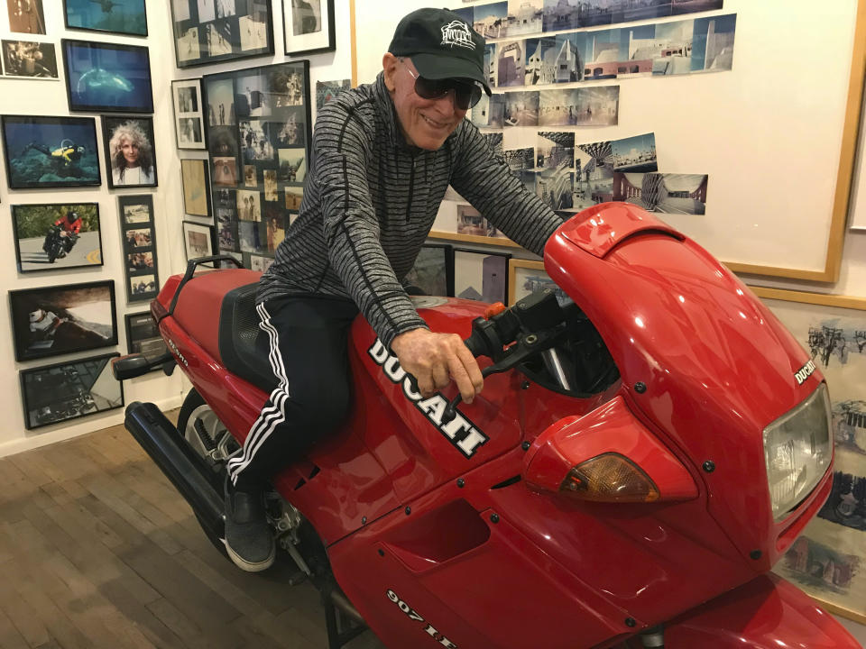 Renowned architect and motorcycle aficionado Antoine Predock sits on his Ducati Paso in his studio in Albuquerque, N.M., April 30, 2018. Predock, whose list of credits includes award-winning buildings around the world, died Saturday, March 2, 2024, at his home in Albuquerque, according to longtime friends and colleagues. He was 87. (AP Photo/Susan Montoya Bryan)