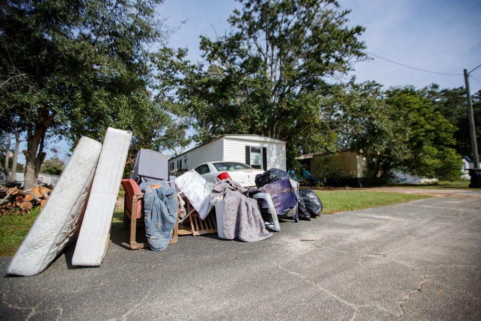 Belongings are placed at the curb for trash pickup in what was previously known as Meadows Mobile Home Park Thursday, Nov. 4, 2021. The property is now under new management and has been renamed Florida Sun Estates. 