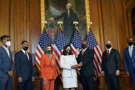 House Speaker Nancy Pelosi of Calif., third from left, poses for a photo during a ceremonial swearing-in Rep. Troy Carter, D-La., third from right, on Capitol Hill in Washington, Tuesday, May 11, 2021. Also in the photo is, from left, Carter's children Joshua Carter, Troy Carter II, Carter's wife Ana Carter, Louisiana Gov. John Bel Edwards and former Democratic Congressman Cedric Richmond, who held the seat before Carter. (AP Photo/Susan Walsh)