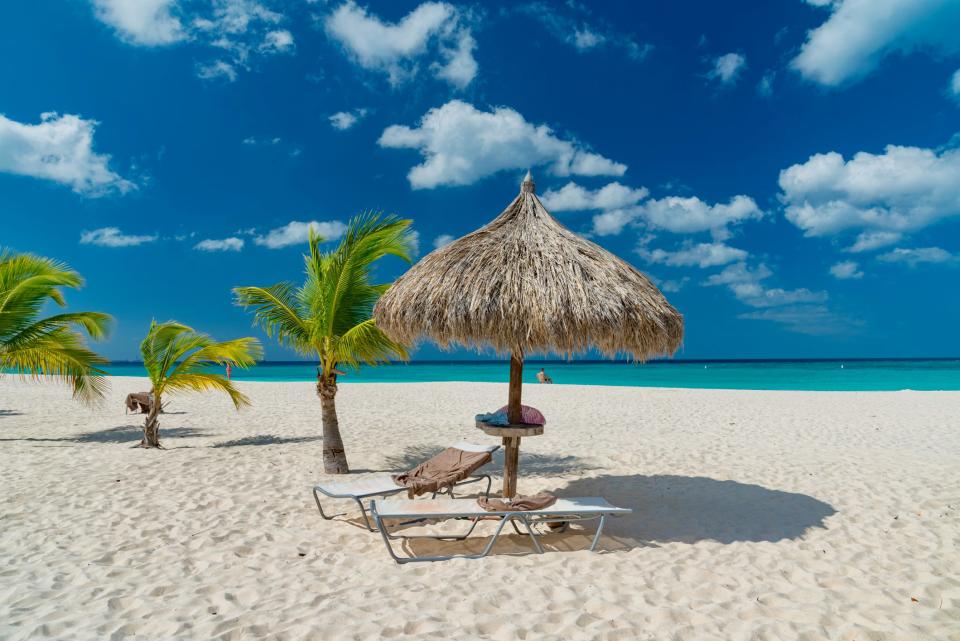 Looking for a touch of paradise, but worried about traveling after the Jamaica travel advisory? There are plenty of safe destinations in the Caribbean, like this white sand beach on the tropical island of Aruba.