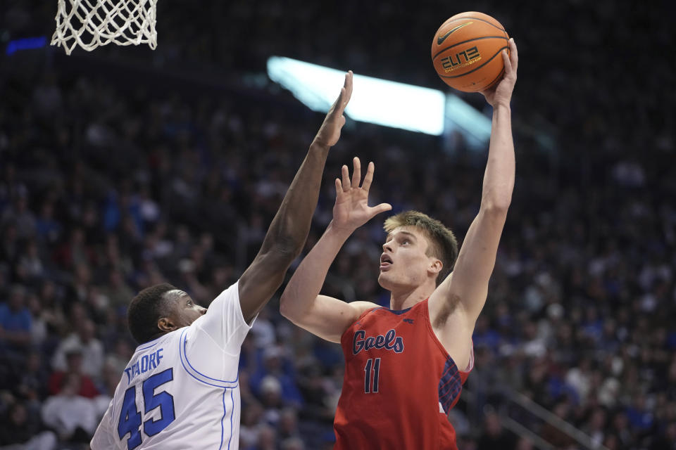 Saint Mary's center Mitchell Saxen (11) shoots over BYU forward Fousseyni Traore (45) during the first half of an NCAA college basketball game Saturday, Jan. 28, 2023, in Provo, Utah. (AP Photo/George Frey)