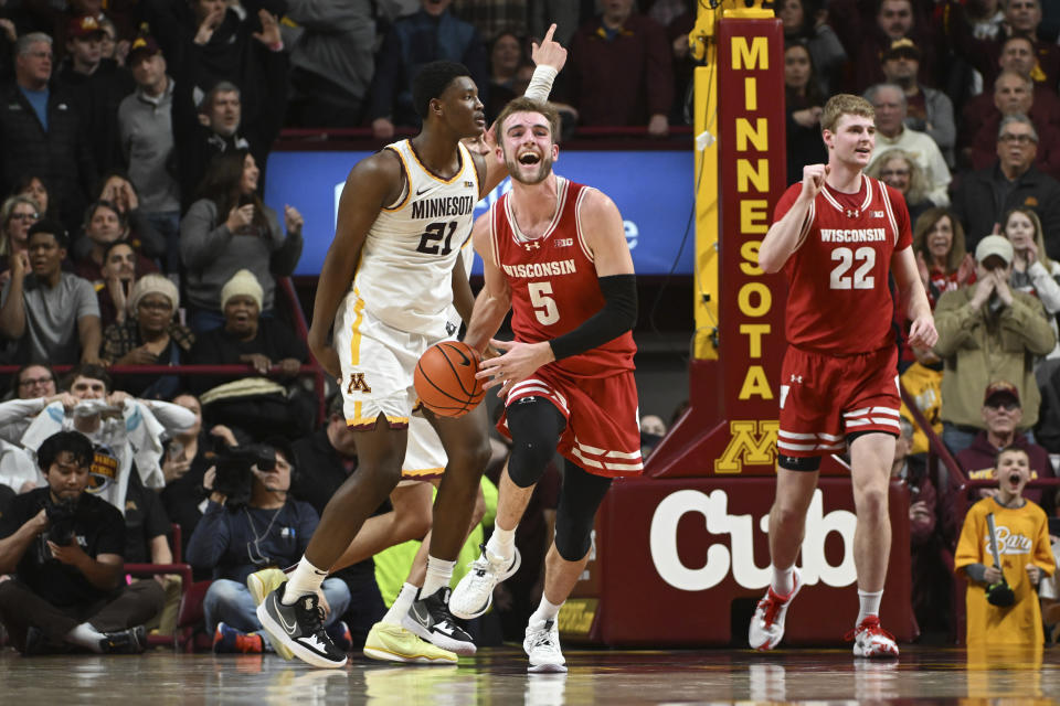 Wisconsin forward Tyler Wahl (5) and forward Steven Crowl (22) celebrate the team's win over Minnesota in an NCAA college basketball game Tuesday, Jan. 23, 2024, in Minneapolis. (AP Photo/Craig Lassig)