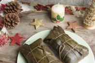 <p>The most traditional Christmas food in Venezuela is <em><a href="https://www.pri.org/stories/2016-12-23/venezuelan-christmas-isnt-christmas-without-hallaca" rel="nofollow noopener" target="_blank" data-ylk="slk:hallaca;elm:context_link;itc:0;sec:content-canvas" class="link ">hallaca</a></em>, which is similar to a tamale. Preparing hallaca takes a very long time, and it is only made during the holidays. Traditionally, family and friends start preparing the ingredients in the morning, which include pork, chicken, raisins, olives, capers, onions, and pimentos, folded into corn dough, then wrapped in a banana leaf. </p>