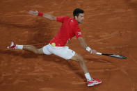 Serbia's Novak Djokovic plays a shot against Greece's Stefanos Tsitsipas in the semifinal match of the French Open tennis tournament at the Roland Garros stadium in Paris, France, Friday, Oct. 9, 2020. (AP Photo/Christophe Ena)