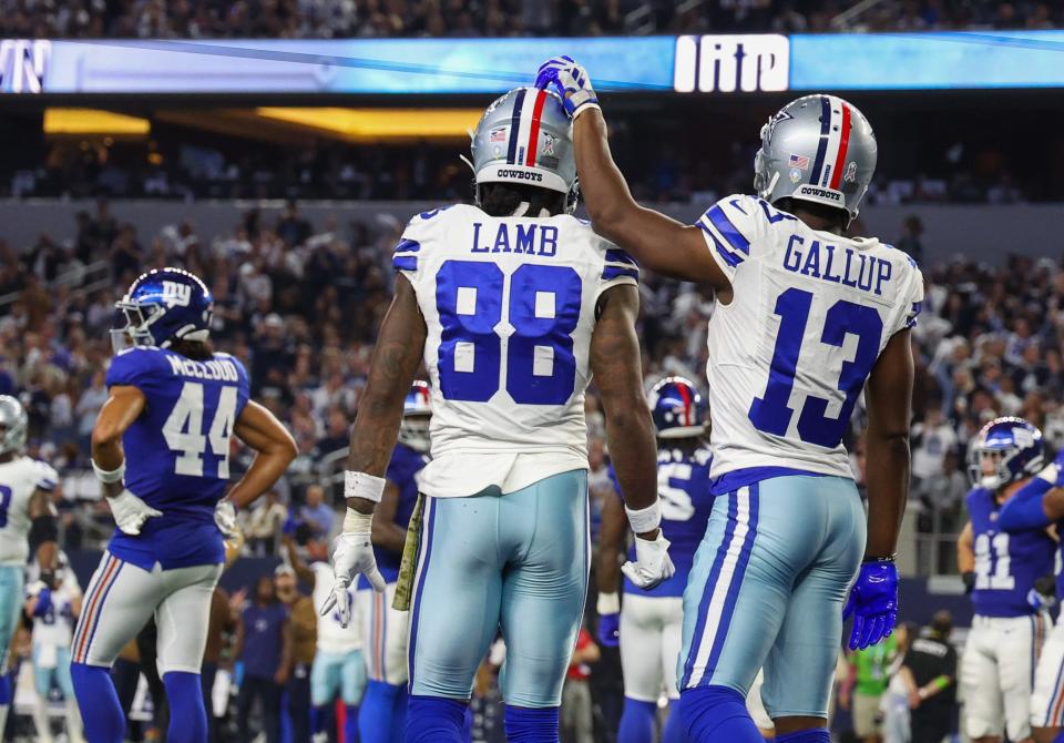 Dallas Cowboys wide receiver CeeDee Lamb and Dallas Cowboys wide receiver Michael Gallup react after a touchdown during the second half against the New York Giants at AT&T Stadium.