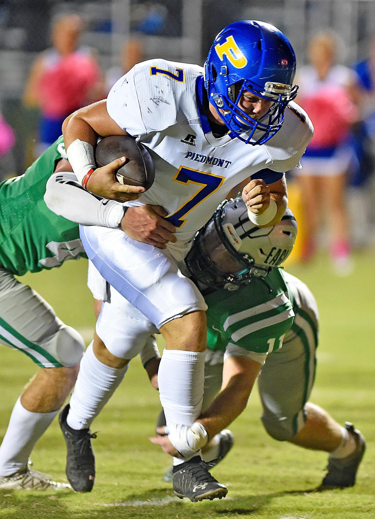 Piedmont quarterback Aaron Jackson Hayes tries to evade the tackle of Hokes Bluff's Layton Horne during high school football action in Hokes Bluff, Alabama October 15, 2021.