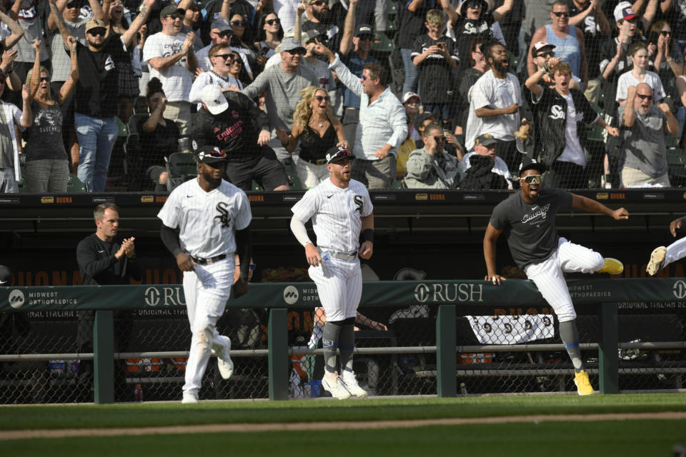 Chicago White Sox players and fans celebrate after Oscar Colas hit a walk-off RBI single to defeat the Baltimore Orioles 7-6 in 10 innings of a baseball game Saturday, April 15, 2023, in Chicago. (AP Photo/Paul Beaty)