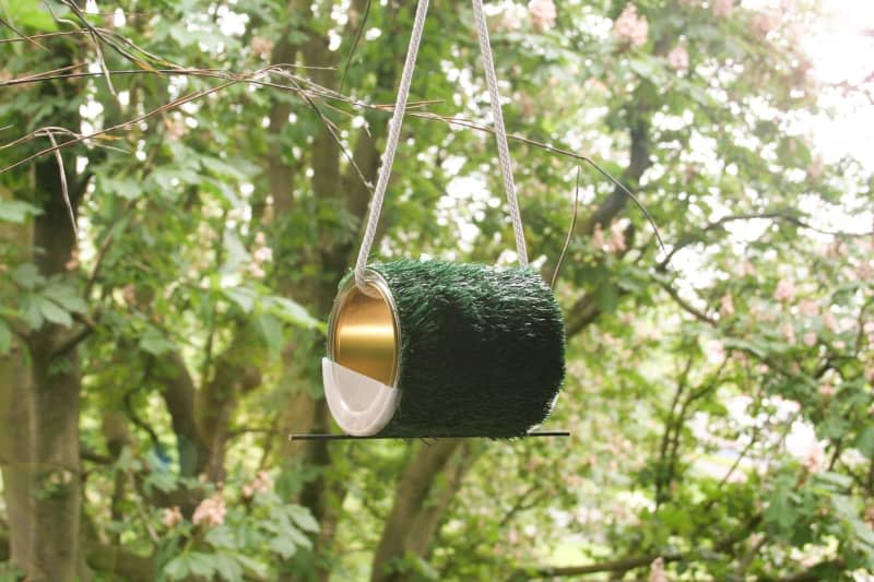 A DIY bird feeder made from an upcycled tin and wrapped in artificial grass fabric. Steffen Rieger/DIY Academy/dpa