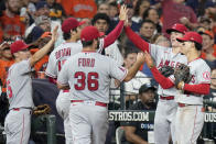 Los Angeles Angels starting pitcher Shohei Ohtani, second from left, high-fives left fielder Mickey Moniak, second from right, after Moniak caught the line drive of Houston Astros' Jeremy Pena and threw out Trey Mancini for a double play to end the fourth inning of a baseball game Saturday, Sept. 10, 2022, in Houston. (AP Photo/Eric Christian Smith)